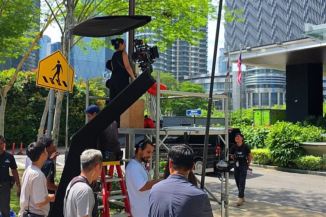 Wanted By Family crew operating a cinema camera on a Kuala Lumpur street set