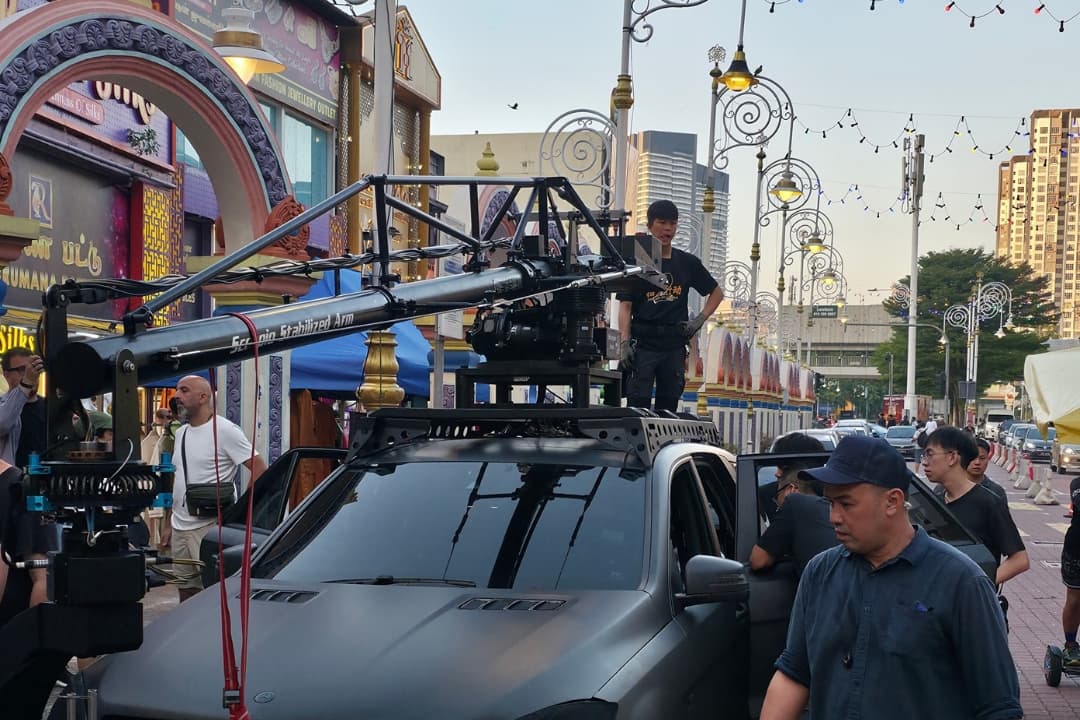 Camera crane and Malaysian production crew filming Wanted By Family on location in Kuala Lumpur